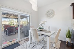 Dining area with dark wood-finish flooring and a crystal chandelier - 