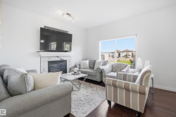 Living area featuring dark wood-finish flooring and white walls - 
