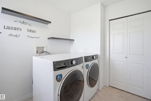 Dedicated laundry space featuring neutral-toned flooring and white walls - 1453 Hays Way, Edmonton, AB - Indoor Photo Showing Laundry Room