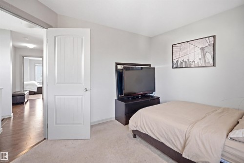 Carpeted room with light neutral wall paint and a white paneled door - 1144 35 Avenue, Edmonton, AB - Indoor Photo Showing Bedroom