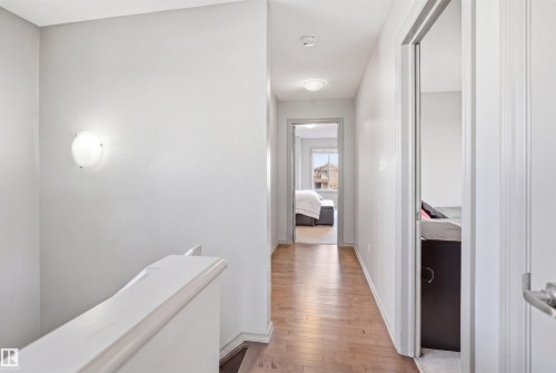 Hallway featuring wood-finish flooring, light grey painted walls, and contemporary flush mount lighting - 1144 35 Avenue, Edmonton, AB - Indoor Photo Showing Other Room