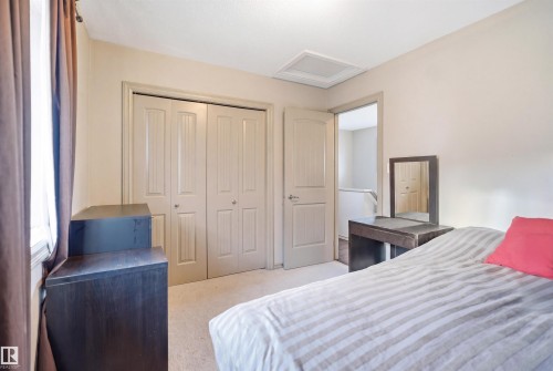 Recessed window with brown drapery, light-colored walls, and matching neutral carpet - 1144 35 Avenue, Edmonton, AB - Indoor Photo Showing Bedroom