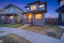 Contemporary two-story home featuring a covered front porch, large windows, and a multi-toned exterior - 1144 35 Avenue, Edmonton, AB  - Outdoor With Deck Patio Veranda 