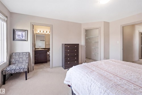 Carpeted bedroom featuring a large window, recessed lighting, and a neutral wall color - 1144 35 Avenue, Edmonton, AB - Indoor Photo Showing Bedroom