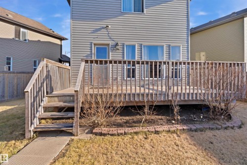Rear exterior featuring a spacious wooden deck with railings, accessible via stairs - 1144 35 Avenue, Edmonton, AB - Outdoor With Deck Patio Veranda