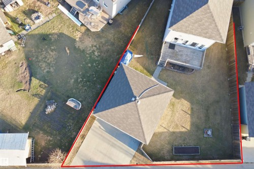Aerial view showcasing the property's footprint with a spacious backyard, concrete driveway, and established fencing - 1144 35 Avenue, Edmonton, AB - Other