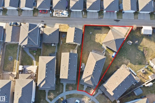 Aerial view showcasing a residential property with a sloped roofline and a generously sized grassy yard - 1144 35 Avenue, Edmonton, AB - 