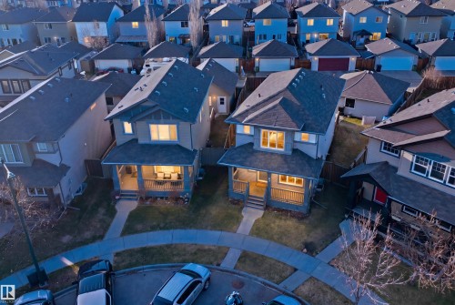 Residential property featuring a covered front porch with railings, a concrete walkway, and an asphalt shingle roof - 1144 35 Avenue, Edmonton, AB - Outdoor With Facade