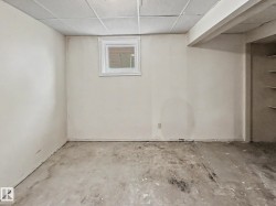 Finished walls and ceiling grid with a small window - 