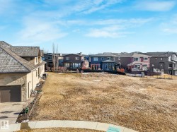 Expansive, undeveloped lot featuring a gentle incline and a clear view of surrounding residences - 