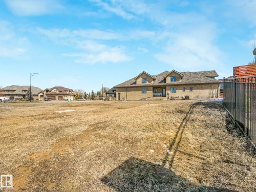 Expansive undeveloped lot featuring a black metal fence along one boundary - 2794 Wheaton Drive, Edmonton, AB 