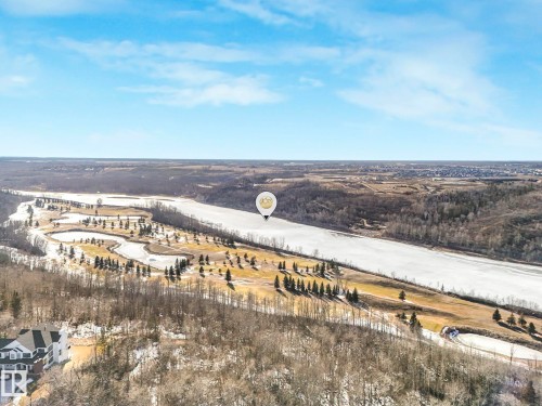 Aerial perspective showcasing a golf course bordering a wide river, surrounded by expansive natural landscapes - 2794 Wheaton Drive, Edmonton, AB 