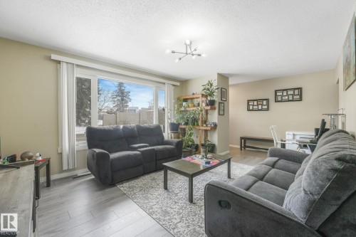 Living area featuring wood-finish flooring and a large picture window - 2 Scarboro Place, St. Albert, AB - Indoor Photo Showing Living Room