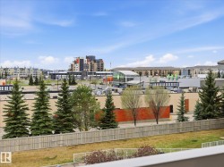 Urban landscape featuring various commercial and residential buildings under a bright sky - 