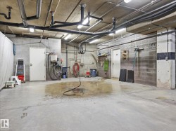 Concrete block walls with exposed overhead utility lines and lighting - 