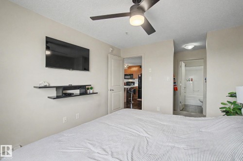 Interior room featuring a ceiling fan with integrated lighting, neutral wall tones, and recessed lighting - 334 504 Albany Way, Edmonton, AB - Indoor Photo Showing Bedroom