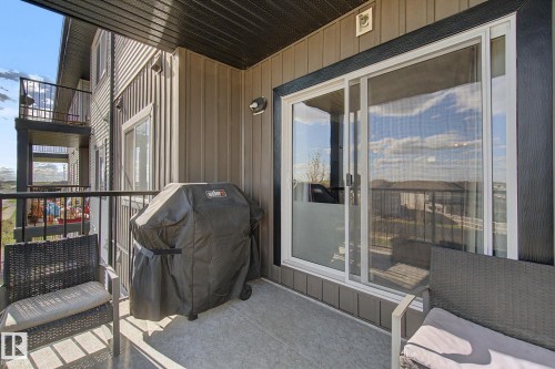 Private balcony featuring a concrete floor and black metal railings - 334 504 Albany Way, Edmonton, AB - Outdoor With Balcony With Exterior