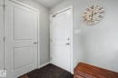 Entryway featuring two paneled doors, light gray wall paint, and a dark textured floor mat - 334 504 Albany Way, Edmonton, AB  - Indoor Photo Showing Other Room 