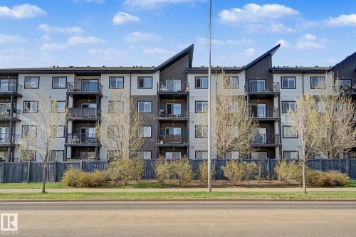 Multi-story residential building featuring a light-colored facade with dark accents - 334 504 Albany Way, Edmonton, AB - Outdoor With Balcony With Facade