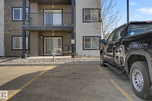 Ground-level patio with sliding glass door access to the interior - 334 504 Albany Way, Edmonton, AB - Outdoor With Balcony