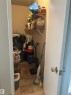 Compact storage closet featuring light-toned walls and durable vinyl flooring - 204 10811 115 Street, Edmonton, AB  - Indoor 