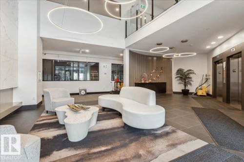 BUILDING LOBBY WITH LINEAR FIREPLACE NAD LEATHER SEATING - 405 7463 May Common, Edmonton, AB - Indoor