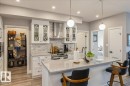 FABULOUS KITCHEN WITH AMO\PLE CABINET SPACE, PANTRY, QUARTZ COUNTERS AND STAINLESS STEEL APPLIANCES - 405 7463 May Common, Edmonton, AB  - Indoor Photo Showing Other Room 