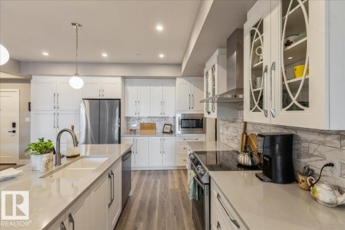 ISLAND WITH ADDITIONAL STORAGE, QUARTZ COUNTER AND SILGRANITE SINK - 405 7463 May Common, Edmonton, AB - Indoor Photo Showing Kitchen With Double Sink With Upgraded Kitchen