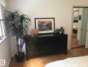 Wood-finish flooring throughout the room with white walls - 9126 117 Street, Edmonton, AB 