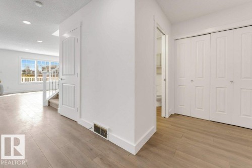 Entryway featuring wood-finish flooring, recessed lighting, and white baseboards - 7403 Singer Landing Landing, Edmonton, AB - Indoor Photo Showing Other Room
