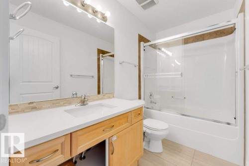 Bathroom featuring a light wood-finish vanity with a white countertop and integrated sink - 7403 Singer Landing Landing, Edmonton, AB - Indoor Photo Showing Bathroom