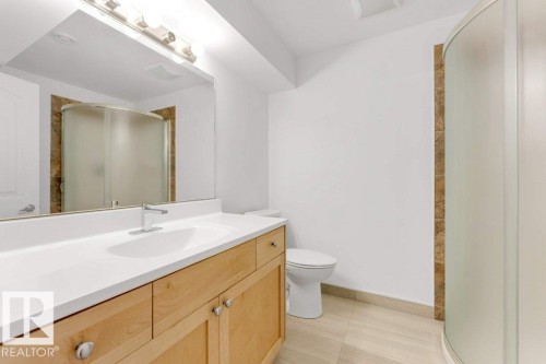 Bathroom featuring a light wood-finish vanity with a white countertop and integrated sink - 7403 Singer Landing Landing, Edmonton, AB - Indoor Photo Showing Bathroom