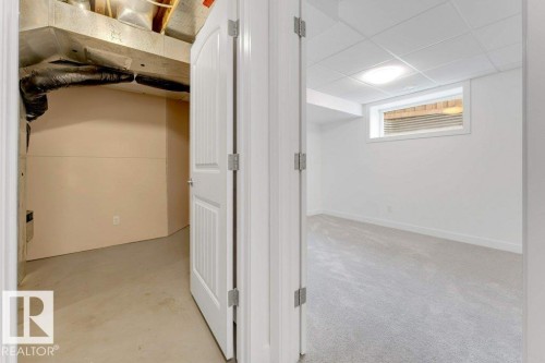 Versatile space featuring a drop ceiling with recessed lighting, light-toned carpeting, and a horizontal window - 7403 Singer Landing Landing, Edmonton, AB - Indoor