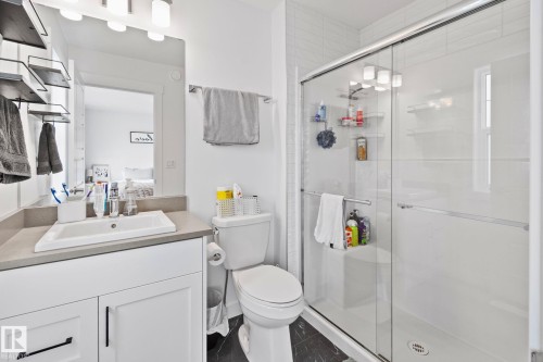 Bathroom featuring a white vanity with a rectangular undermount sink, a gray countertop, and contemporary black hardware - 21027 130 Avenue, Edmonton, AB - Indoor Photo Showing Bathroom
