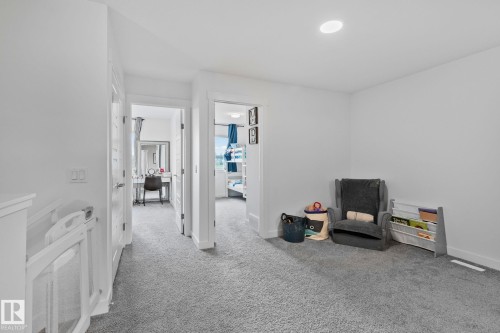 Carpeted hallway featuring bright white walls and recessed lighting - 21027 130 Avenue, Edmonton, AB - Indoor