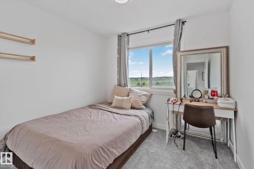 Bright room with light grey carpet and white walls - 21027 130 Avenue, Edmonton, AB - Indoor Photo Showing Bedroom