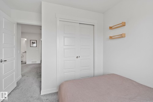 White paneled bi-fold closet doors - 21027 130 Avenue, Edmonton, AB - Indoor Photo Showing Bedroom
