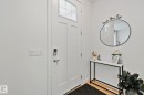 Entryway featuring a white paneled door with transom window, modern door hardware, and wood-finish flooring - 21027 130 Avenue, Edmonton, AB  - Indoor Photo Showing Other Room 