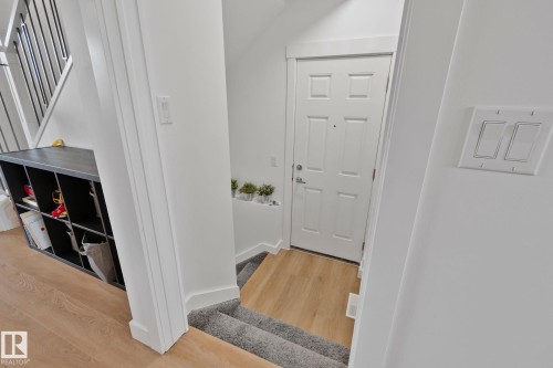Multi-panel interior door with light wood-finish flooring - 21027 130 Avenue, Edmonton, AB - Indoor Photo Showing Other Room