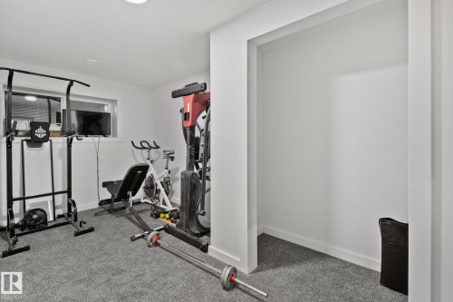 Carpeted room with white walls, a single recessed light, and a window - 21027 130 Avenue, Edmonton, AB - Indoor Photo Showing Gym Room