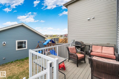 Spacious exterior deck featuring composite decking, white railing, and ample room for outdoor seating - 21027 130 Avenue, Edmonton, AB - Outdoor With Deck Patio Veranda With Exterior