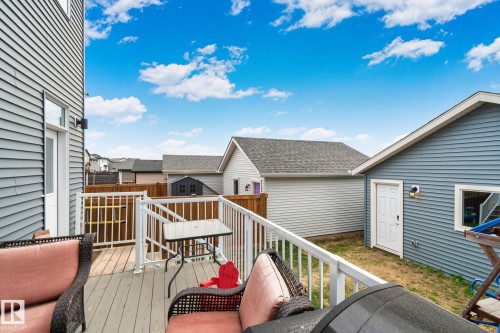 Backyard deck featuring composite decking, white railing, and a private wooden fence - 21027 130 Avenue, Edmonton, AB - Outdoor With Exterior