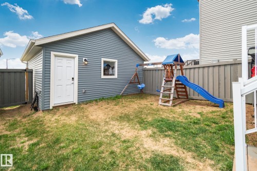 Detached garage with horizontal siding, a side entry door, and an exterior light fixture - 21027 130 Avenue, Edmonton, AB - Outdoor