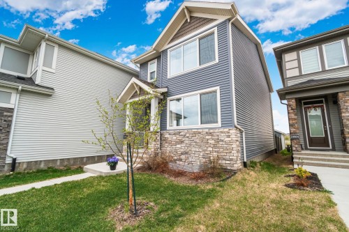 Modern two-story residence featuring a blue siding exterior with stone veneer accents - 21027 130 Avenue, Edmonton, AB - Outdoor