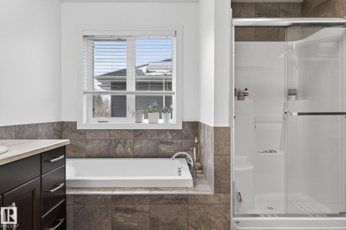The bathroom features a bathtub and a glass-enclosed shower - 26 Edgewater Terr N, St. Albert, AB - Indoor Photo Showing Bathroom