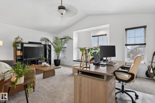 This inviting interior space features a vaulted ceiling, light-colored carpet, and windows equipped with blinds - 26 Edgewater Terr N, St. Albert, AB - Indoor Photo Showing Office
