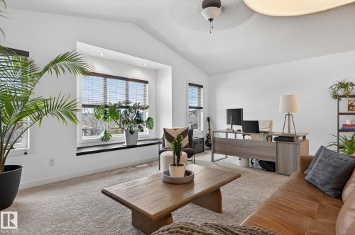Bright, spacious room featuring a vaulted ceiling, recessed lighting, and a large window with blinds - 26 Edgewater Terr N, St. Albert, AB - Indoor Photo Showing Living Room
