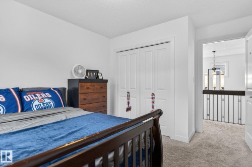 This room features a closet with bi-fold doors, light-colored walls, and carpeting - 26 Edgewater Terr N, St. Albert, AB - Indoor Photo Showing Bedroom