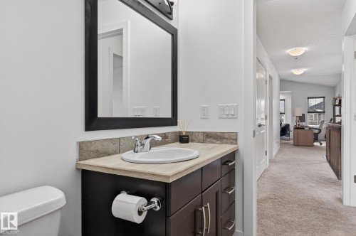 Well-appointed bathroom featuring a vanity with a light-colored countertop and a rectangular mirror - 26 Edgewater Terr N, St. Albert, AB - Indoor Photo Showing Bathroom