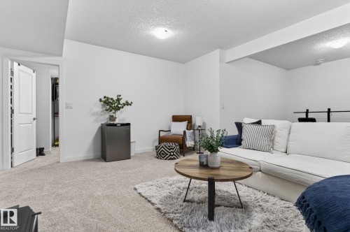 Spacious living area featuring light-colored carpeting, white walls, and recessed lighting - 26 Edgewater Terr N, St. Albert, AB - Indoor Photo Showing Other Room